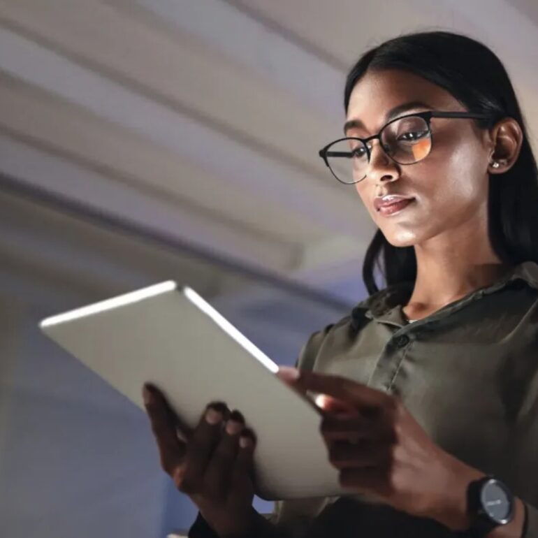 young attractive businesswoman in the office looking at a tablet