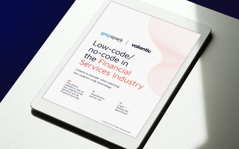 White tablet showing the title page of the Trend Report "Low-code/no-code in the Financial Industry", positioned on a white table with natural light and shadow.